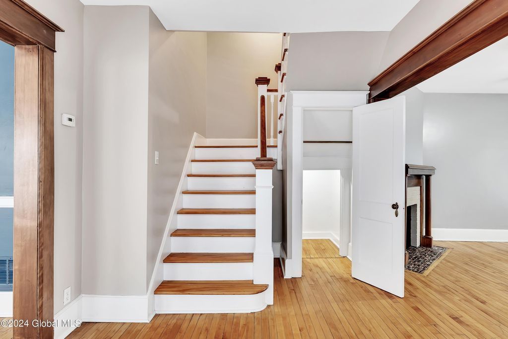 An empty room with stairs leading up to the second floor