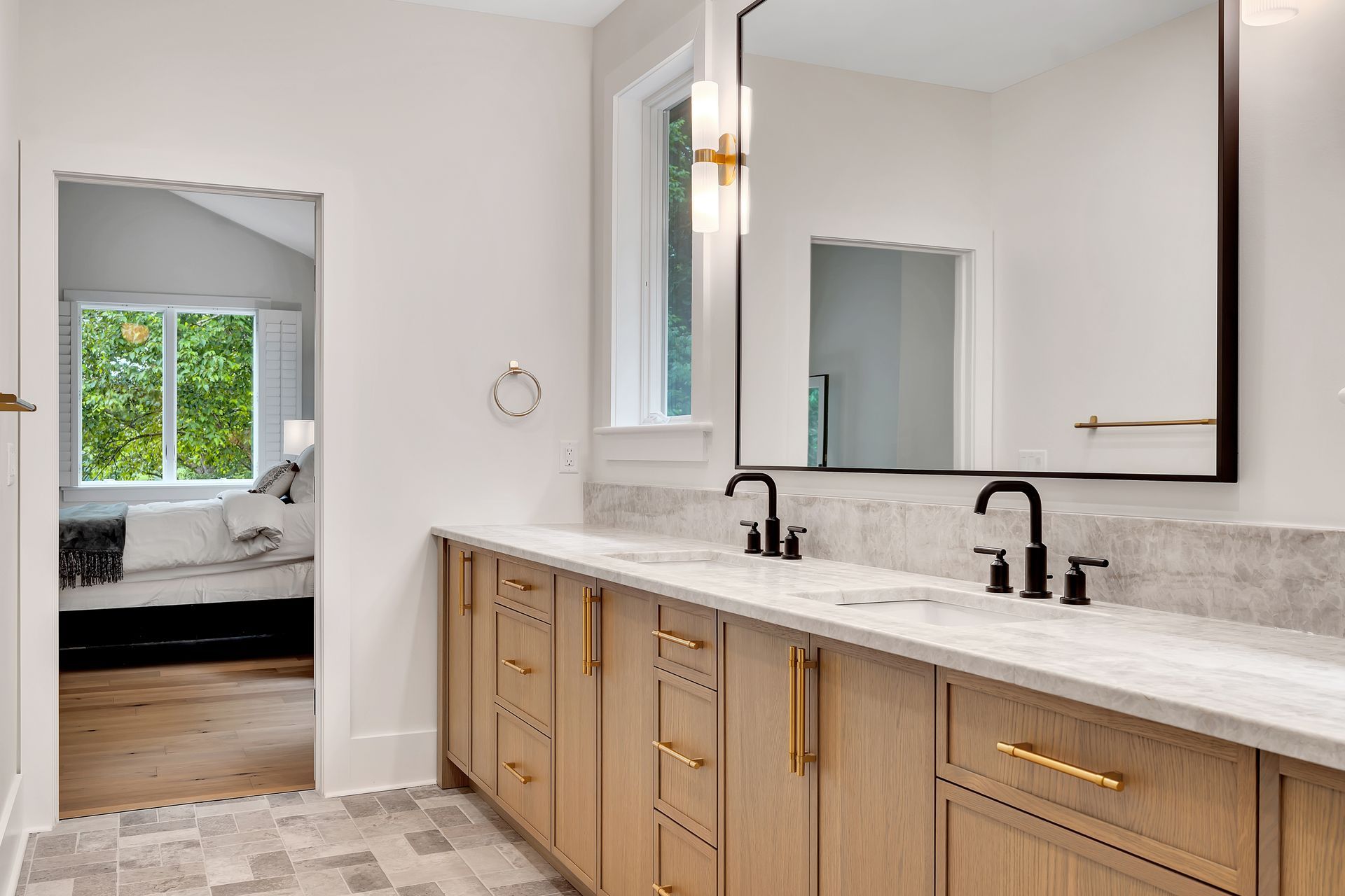A bathroom with two sinks and a large mirror.