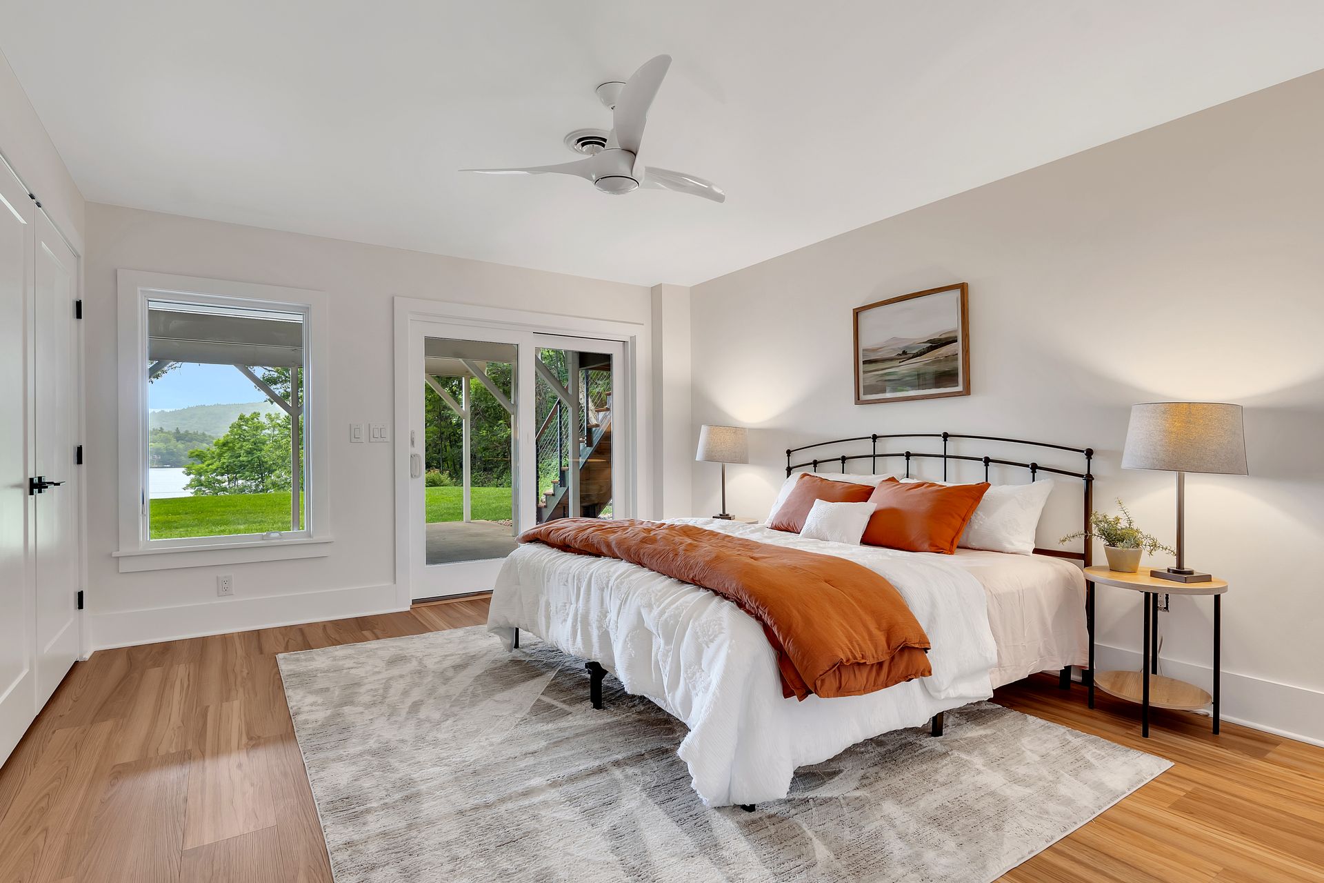 A bedroom with a large bed and a ceiling fan.