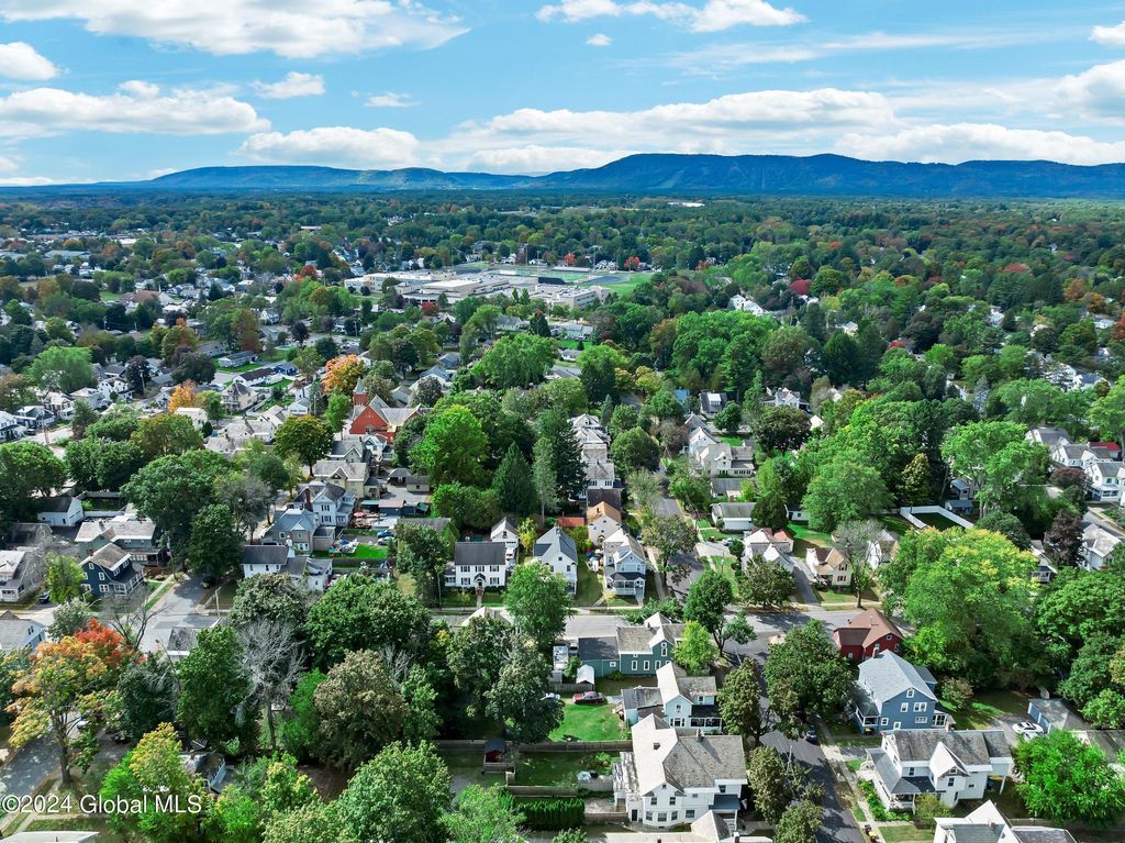 An aerial view of a residential area filled with lots of trees and houses.