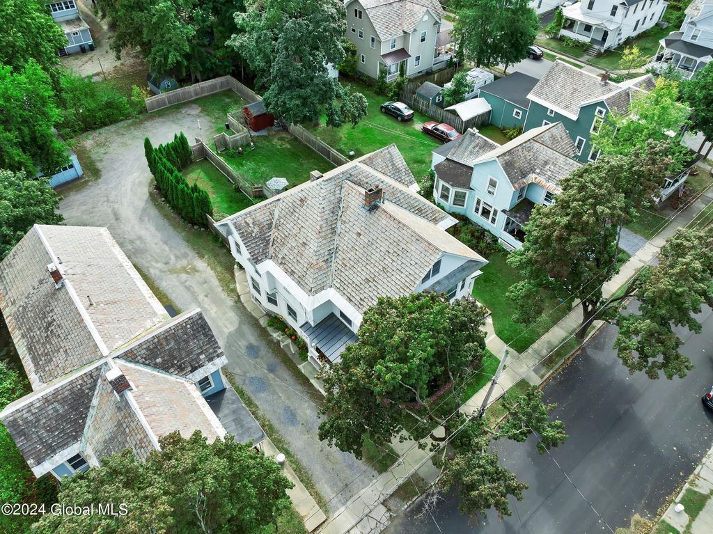 An aerial view of a residential neighborhood with lots of houses and trees.