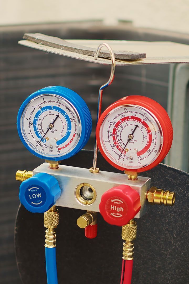 A couple of gauges are sitting on top of each other on a table.