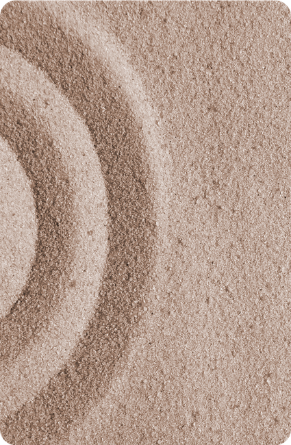 Concentric circles raked into light-brown sand.
