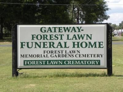 Sign for Gateway-Forest Lawn Funeral Home with address numbers, green text on white, and black border.