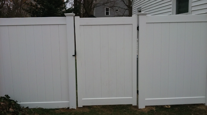 White vinyl fence with gate, outdoors.