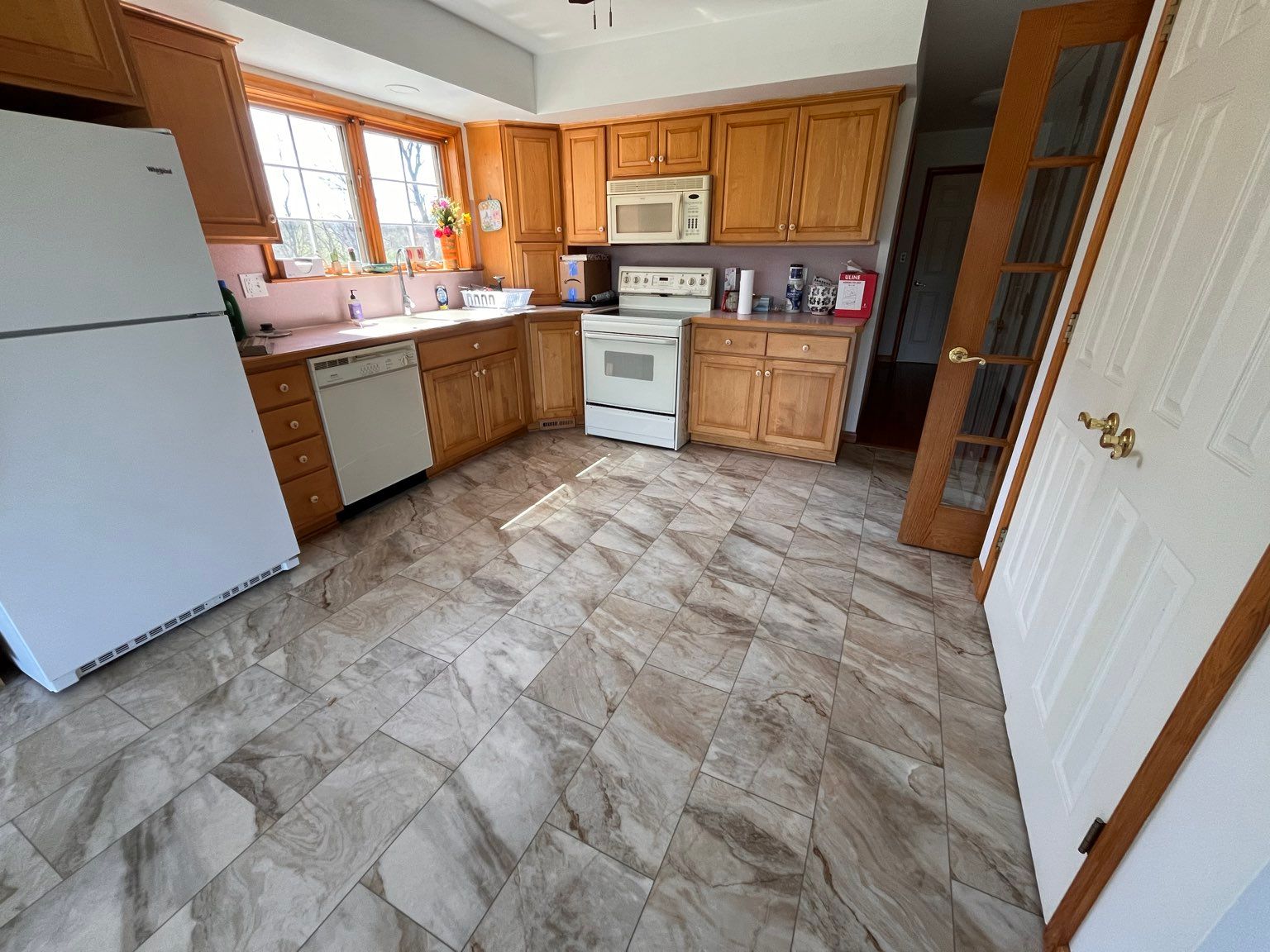 A kitchen with new flooring by Floor Source