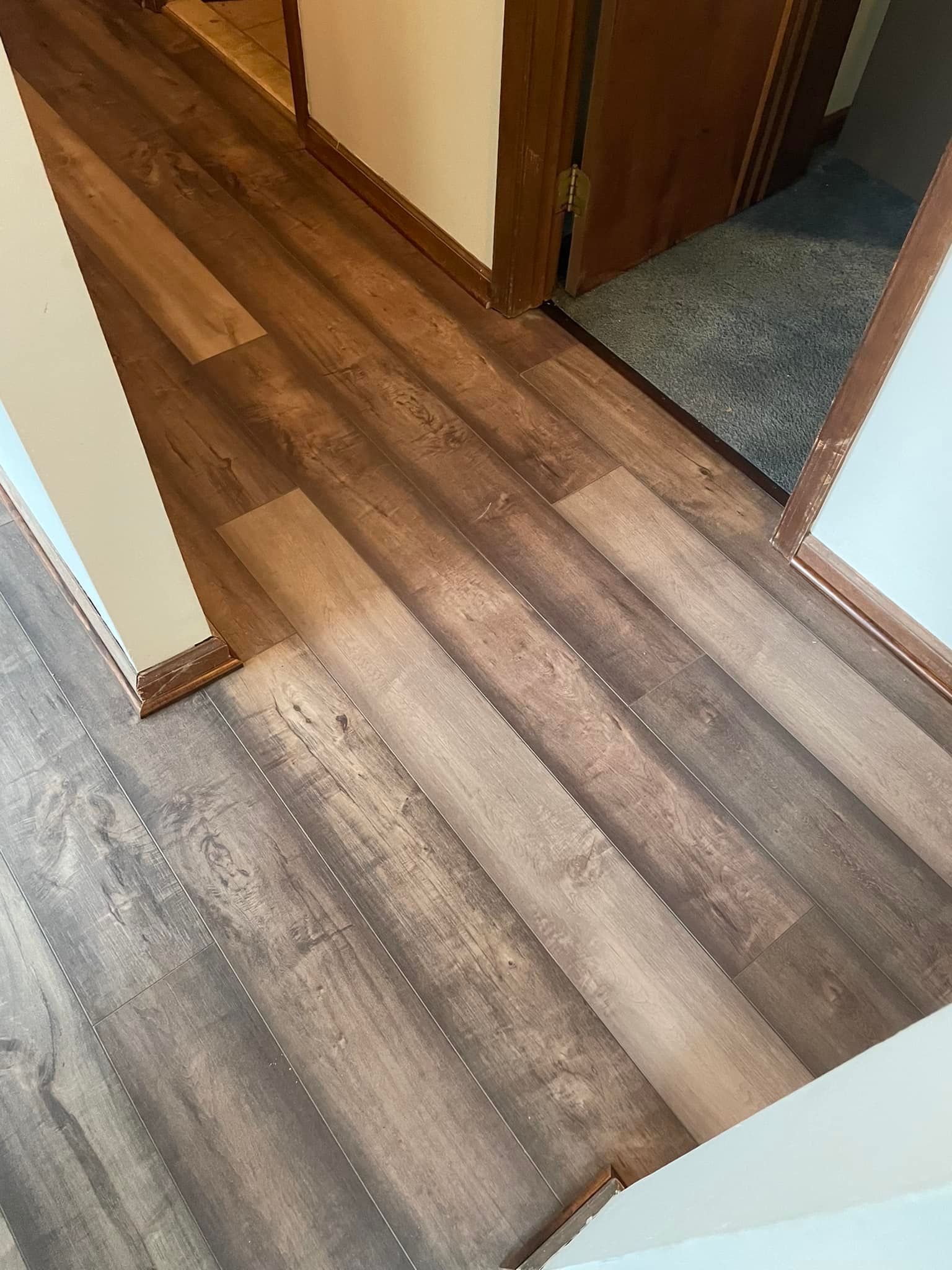A hallway with a wooden flooring by Floor Source