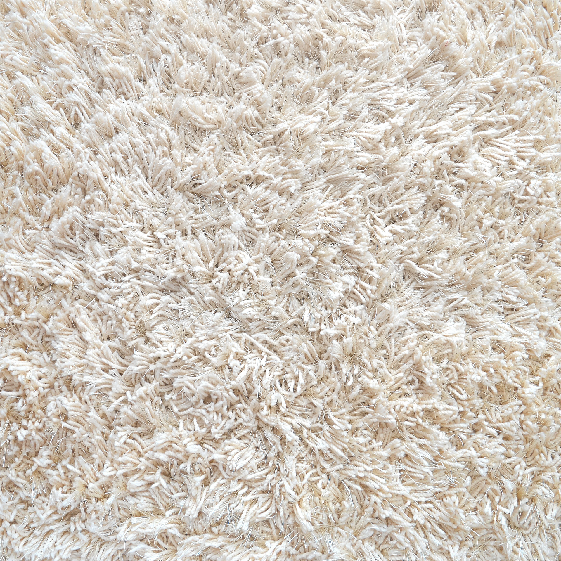 A close up of a white fluffy rug.