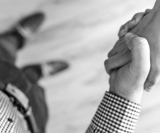 A black and white photo of two people shaking hands