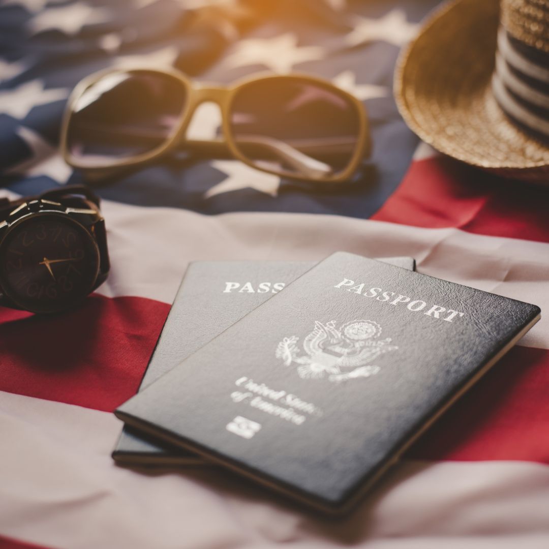 a pair of passports sitting on top of an american flag
