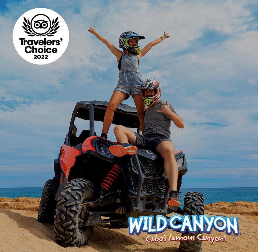 a man and a woman are sitting on top of a atv .
