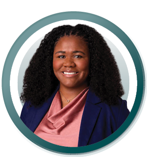 Studio headshot of a smiling person in a navy blazer and pink top inside a teal circular frame