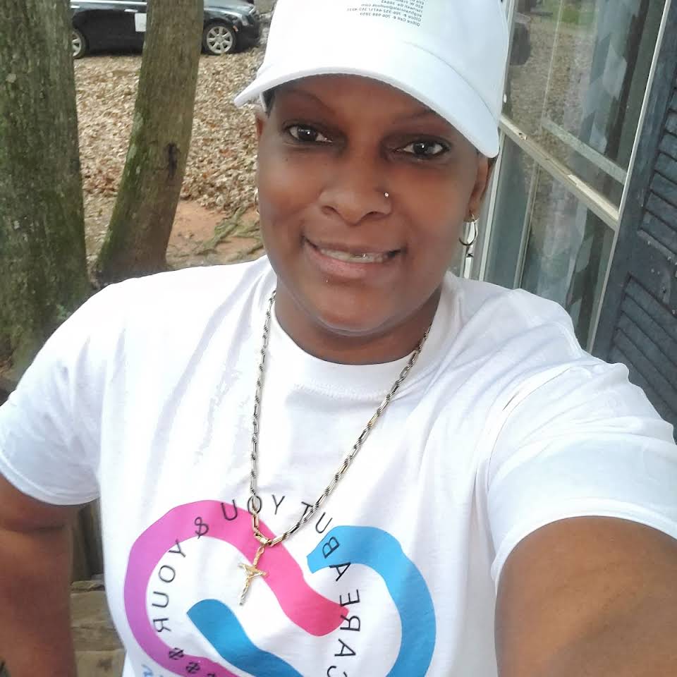 A woman wearing a white hat and a t-shirt with a heart on it