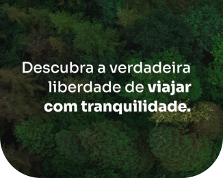 An aerial view of a forest with the words descubra a verdadeira liberdade de viajar com tranquilidade