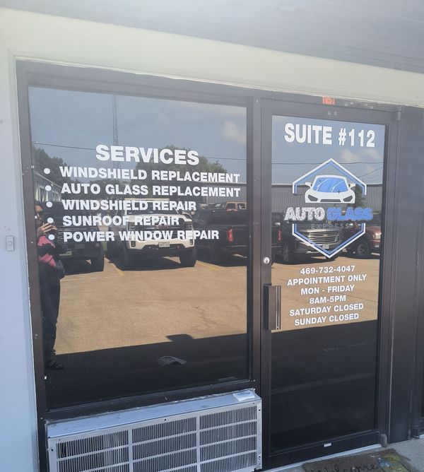 Auto repair shop storefront with service list and suite number 112 on the door