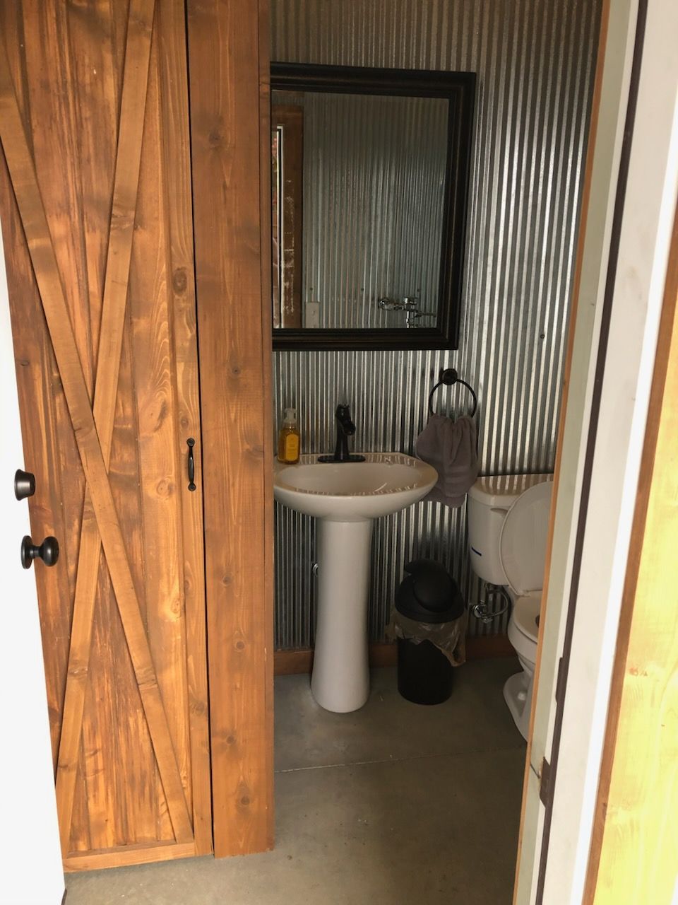 A bathroom with a sink , toilet and mirror.