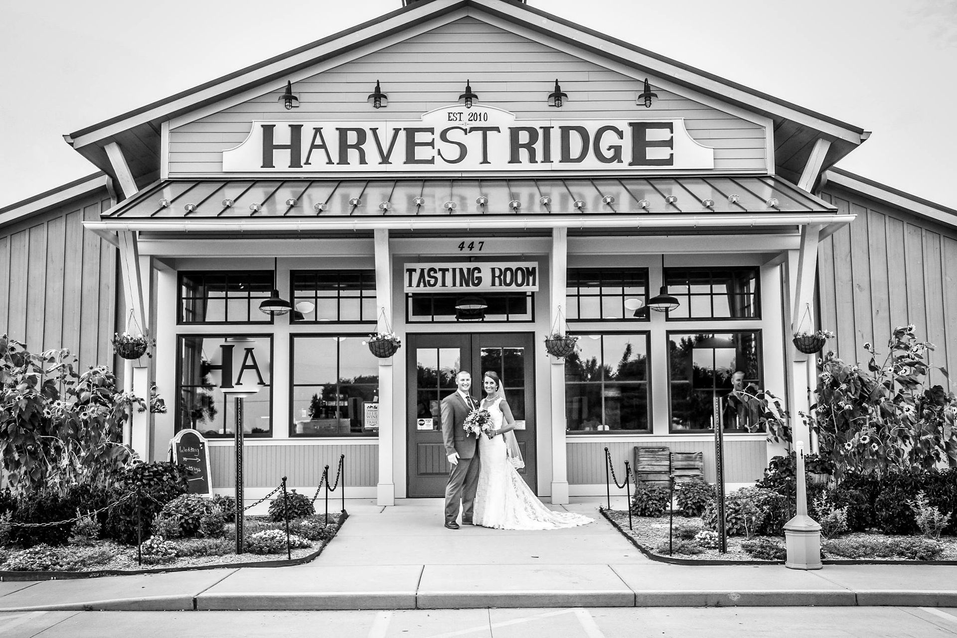 bride and groom in front of venue entrance