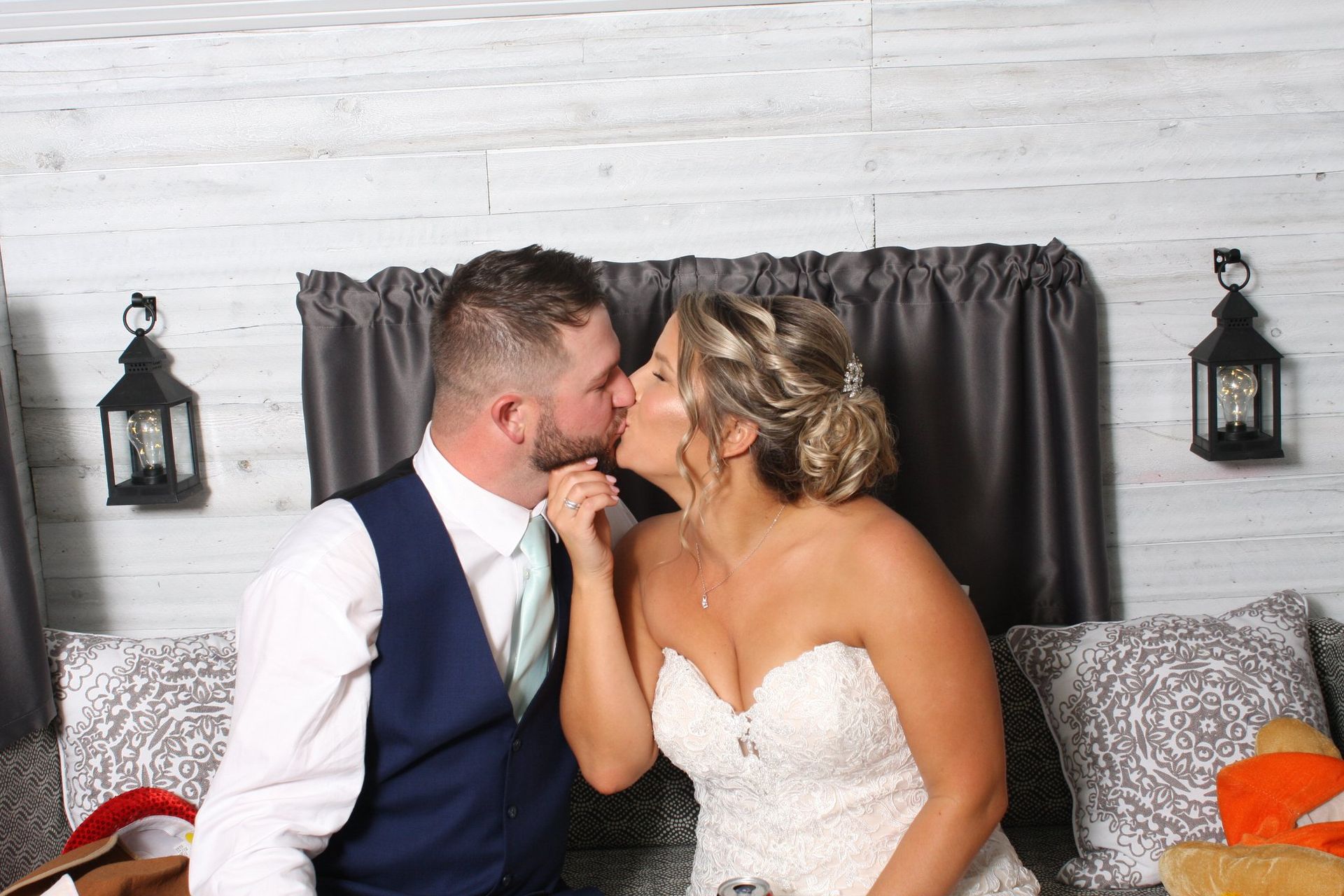 bride and groom kissing in photo booth