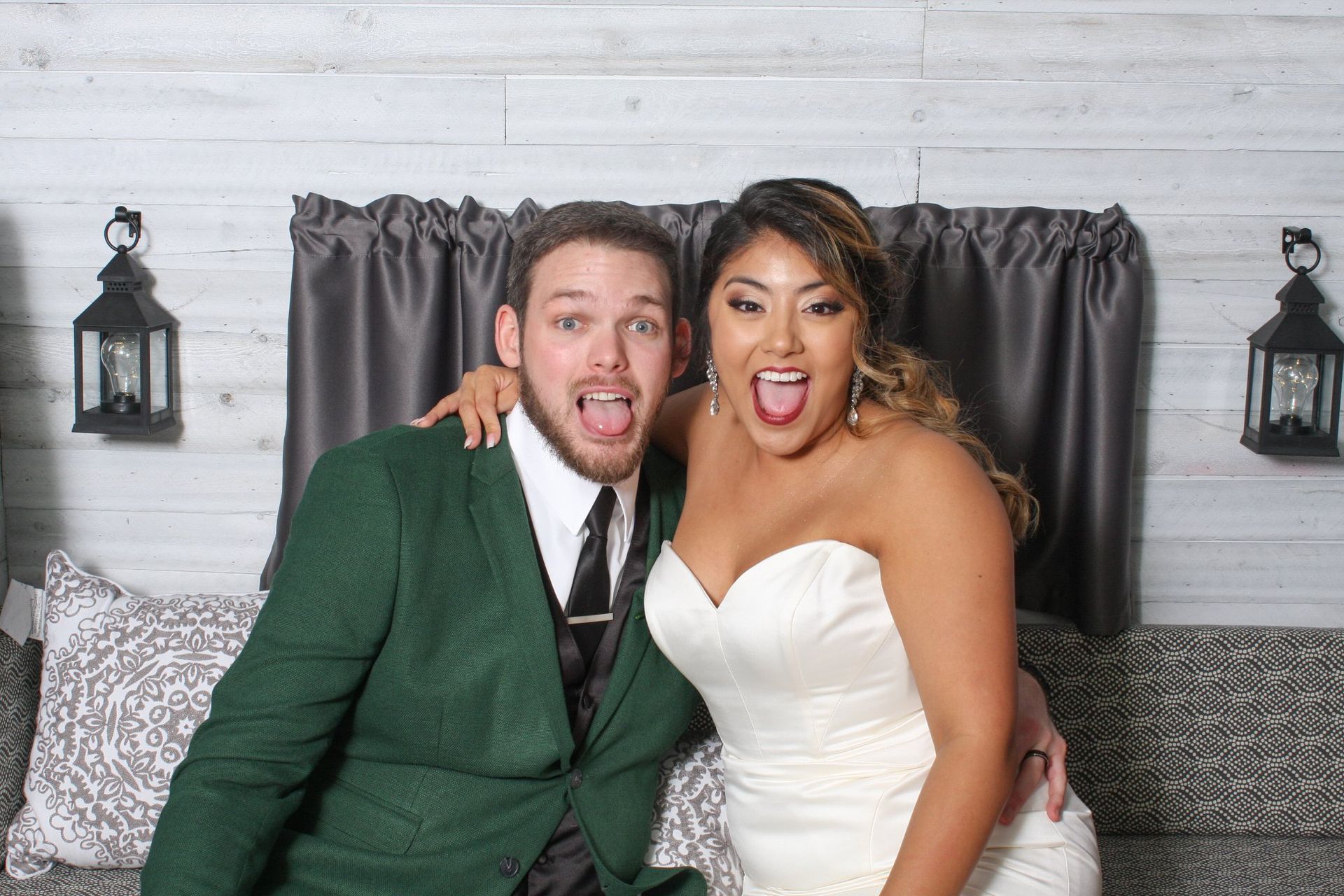 bride and groom posing for photo booth photo