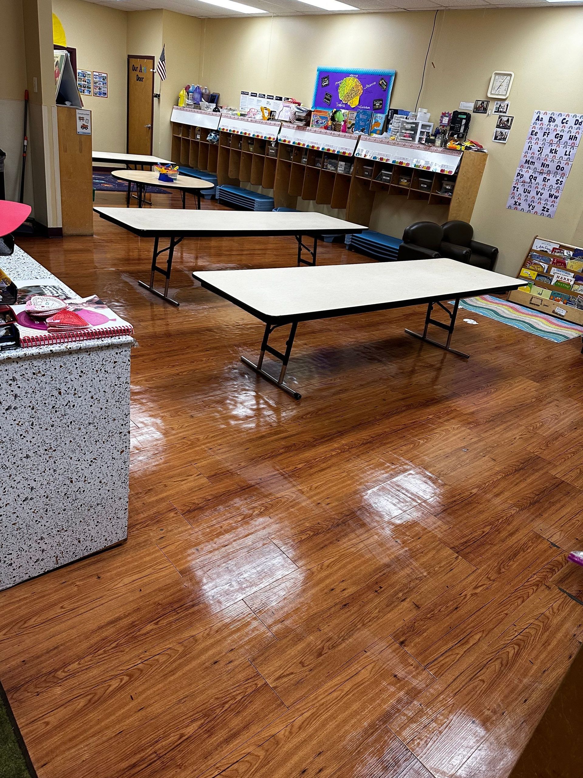 A room with wooden floors and tables in it.