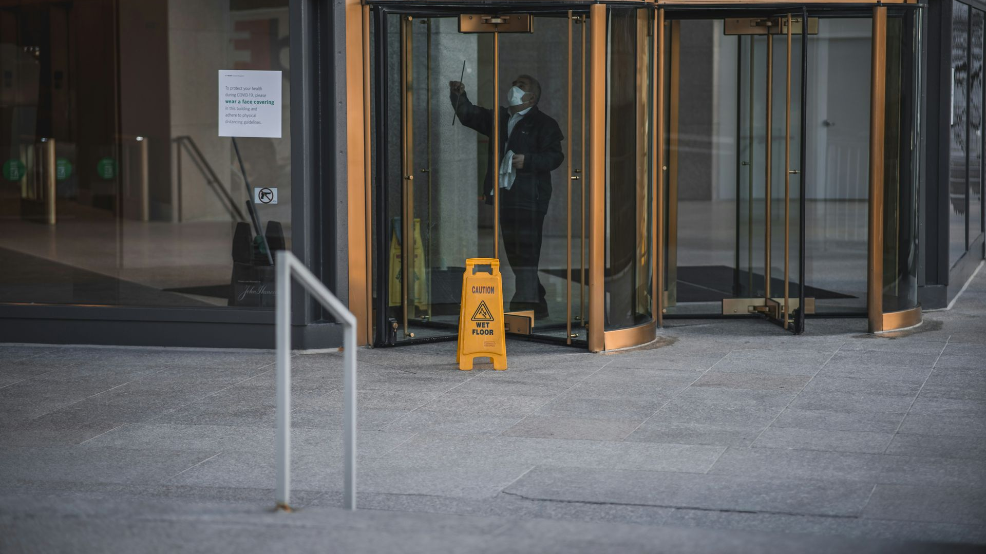 Person in uniform near revolving door;