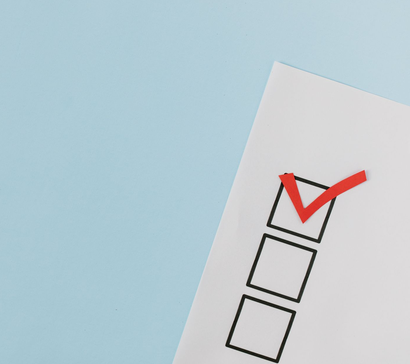 Checked checkbox on a white checklist against a light blue background