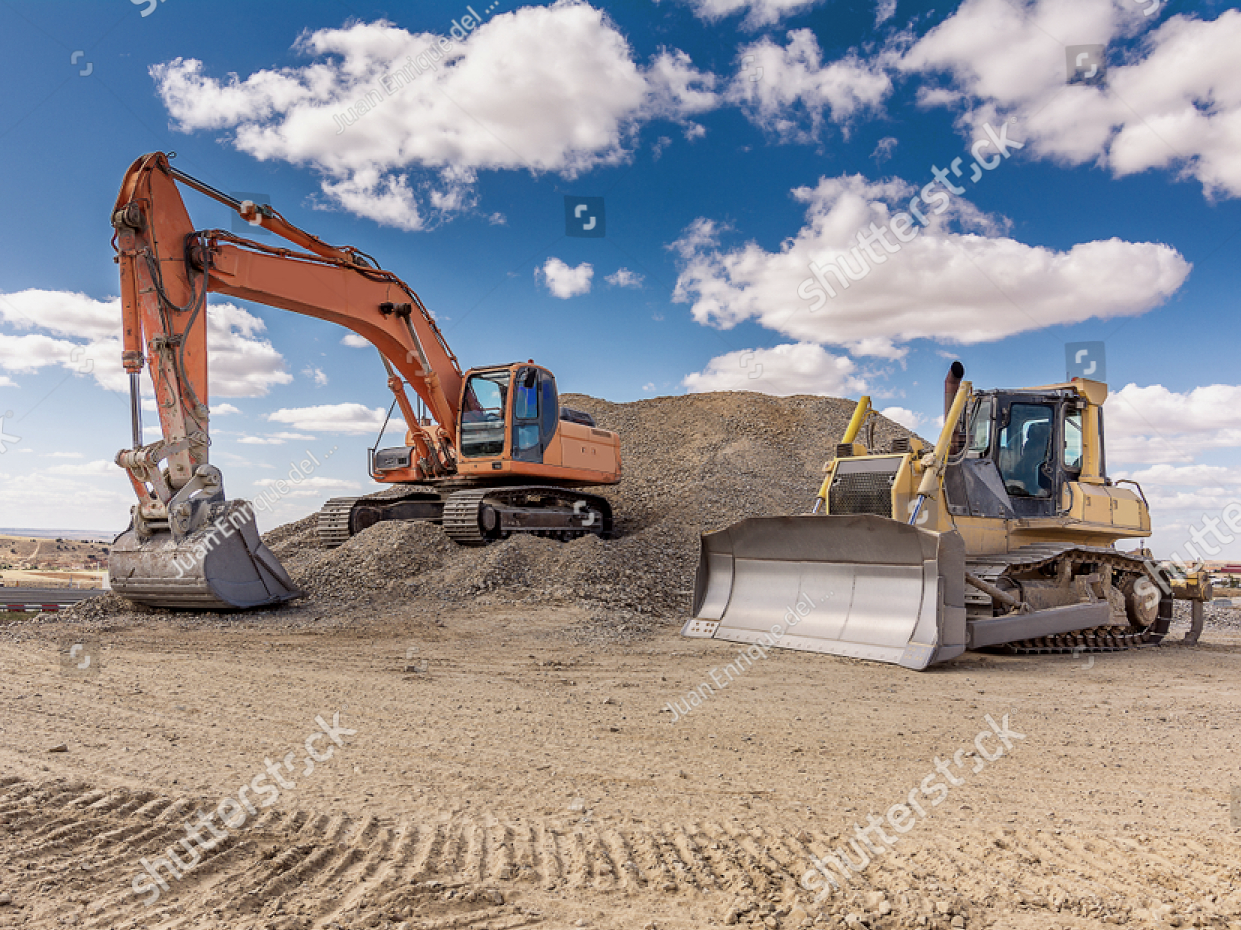 Orange excavator and yellow bulldozer on a gravel pile under a blue sky with clouds. Construction site.