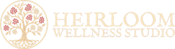 Heirloom Wellness Studio logo with gold text and a floral tree illustration on a white background