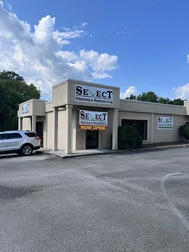 Exterior of a Select Nutrition & Wellness store with a white SUV parked in front.