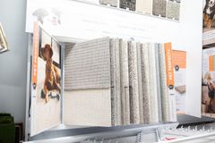 Carpet sample display: various neutral-toned carpet swatches with information about pet-friendly features.
