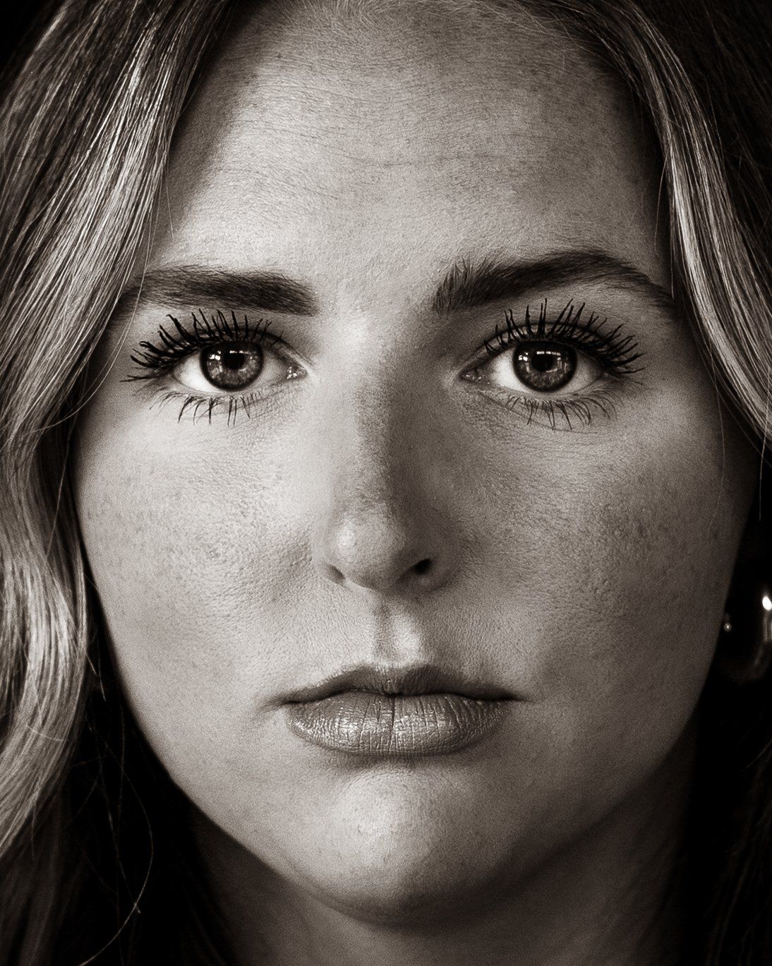 A close up of a woman 's face in a black and white photo