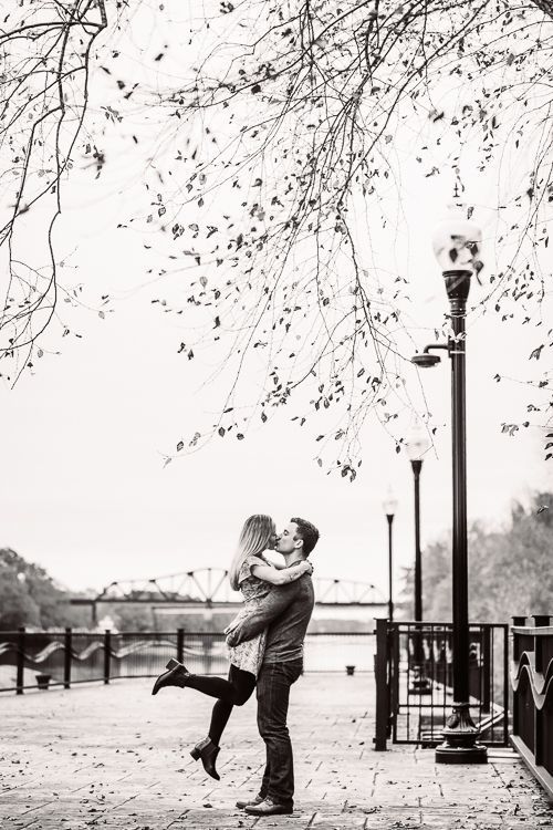 A black and white photo of a man holding a woman in his arms.