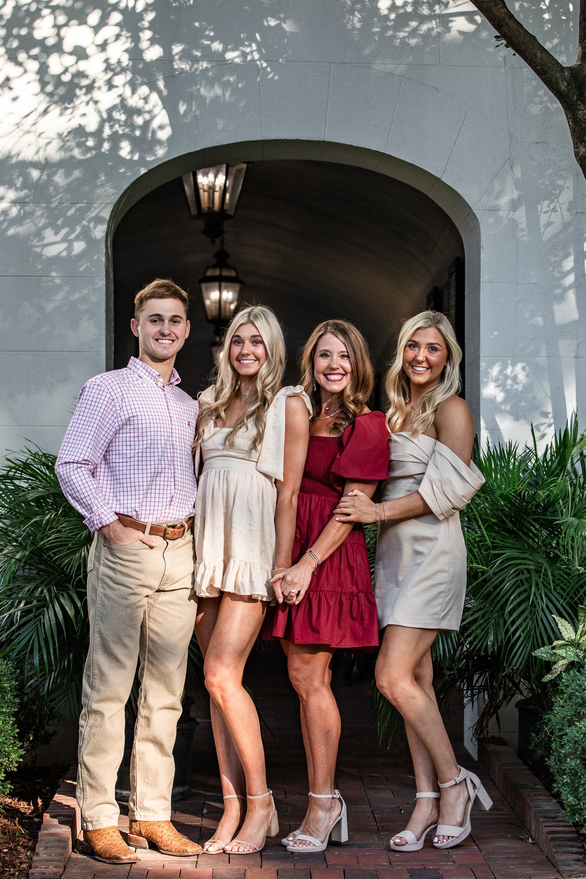A group of people are posing for a picture in front of a building.