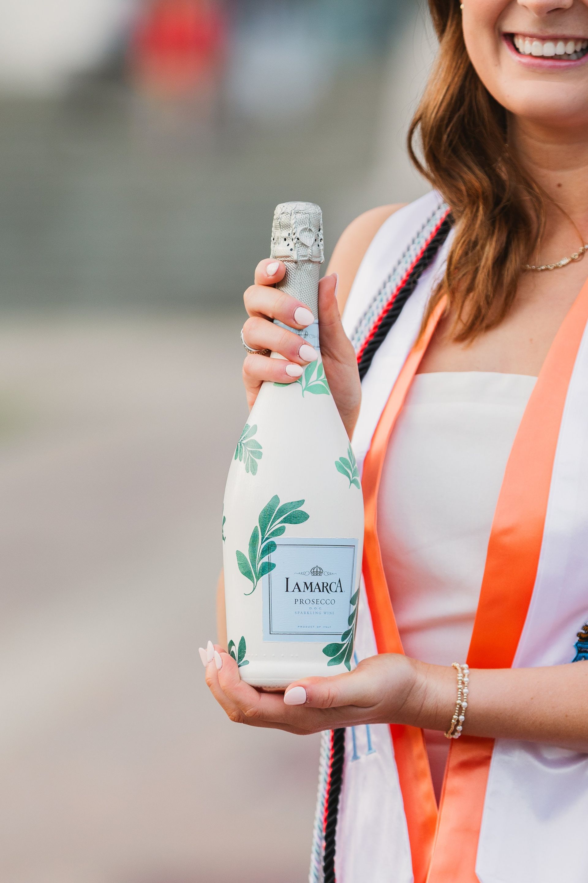 A woman is holding a bottle of champagne in her hand.