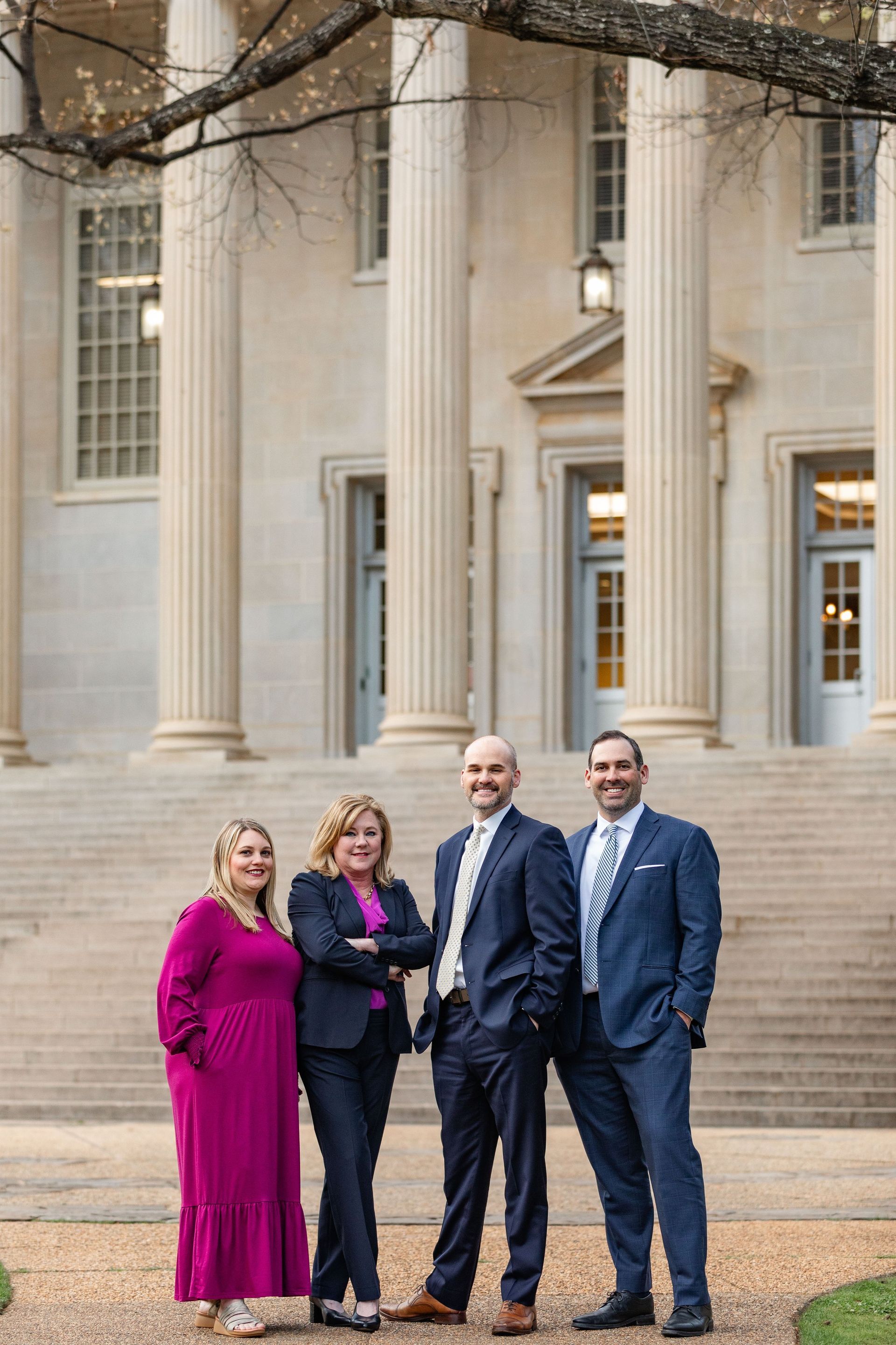 A group of people in suits are standing in front of a building.
