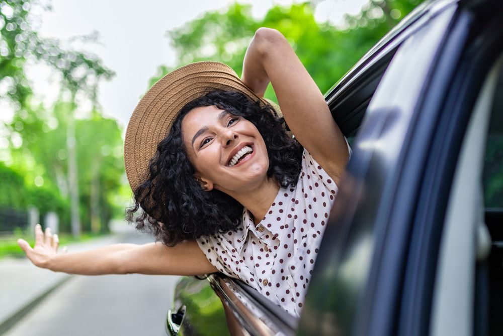 Woman on a Car Enjoying Her Ride