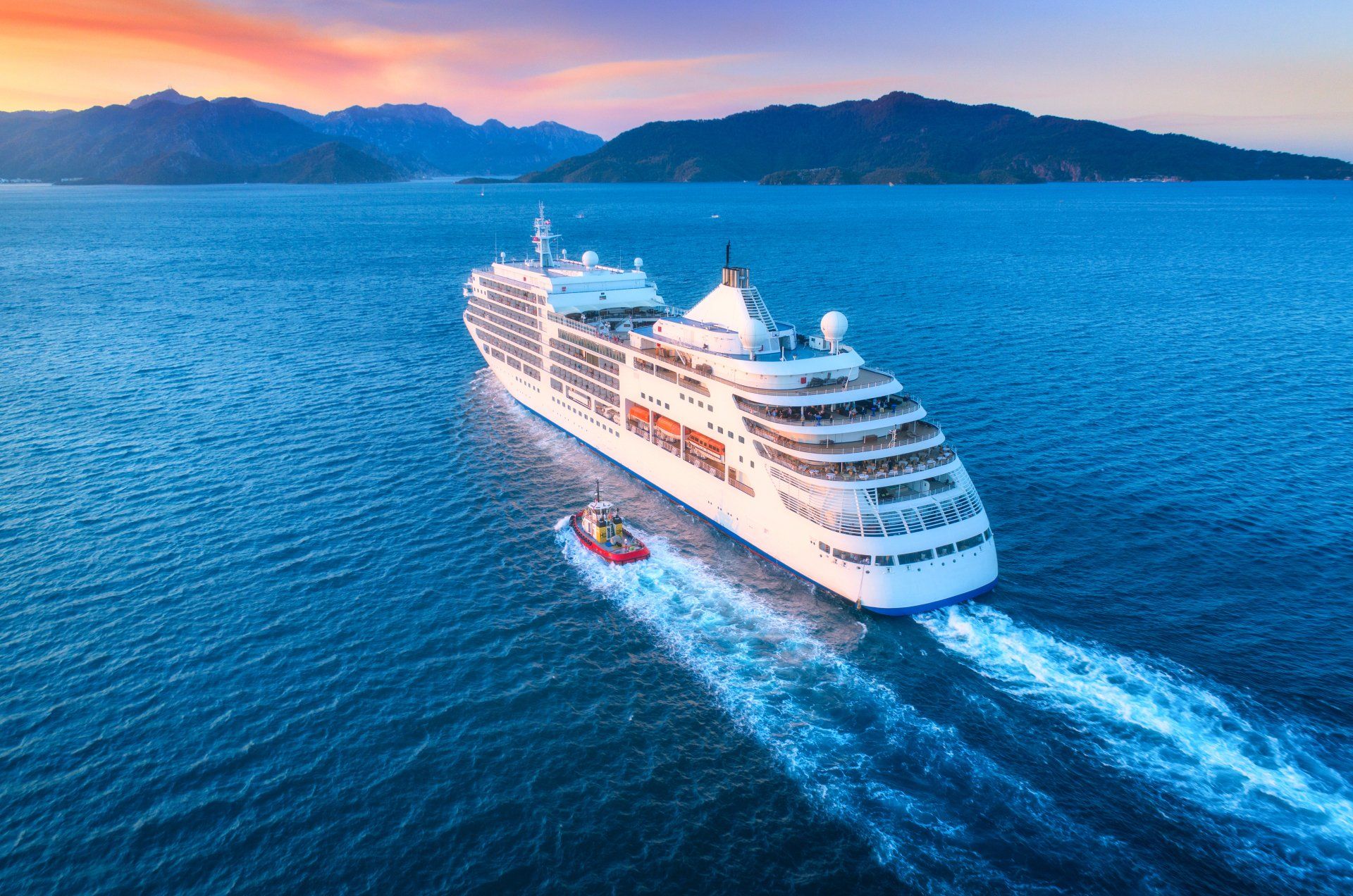 Cruise ship at harbor. Aerial view of beautiful large white ship at sunset.