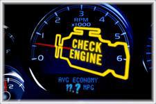 A car dashboard with a check engine light on it.