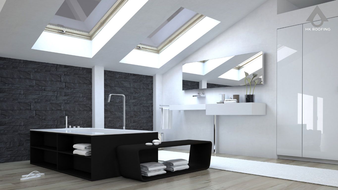 Modern bathroom with skylights, black bathtub, white sink, and dark gray wall.