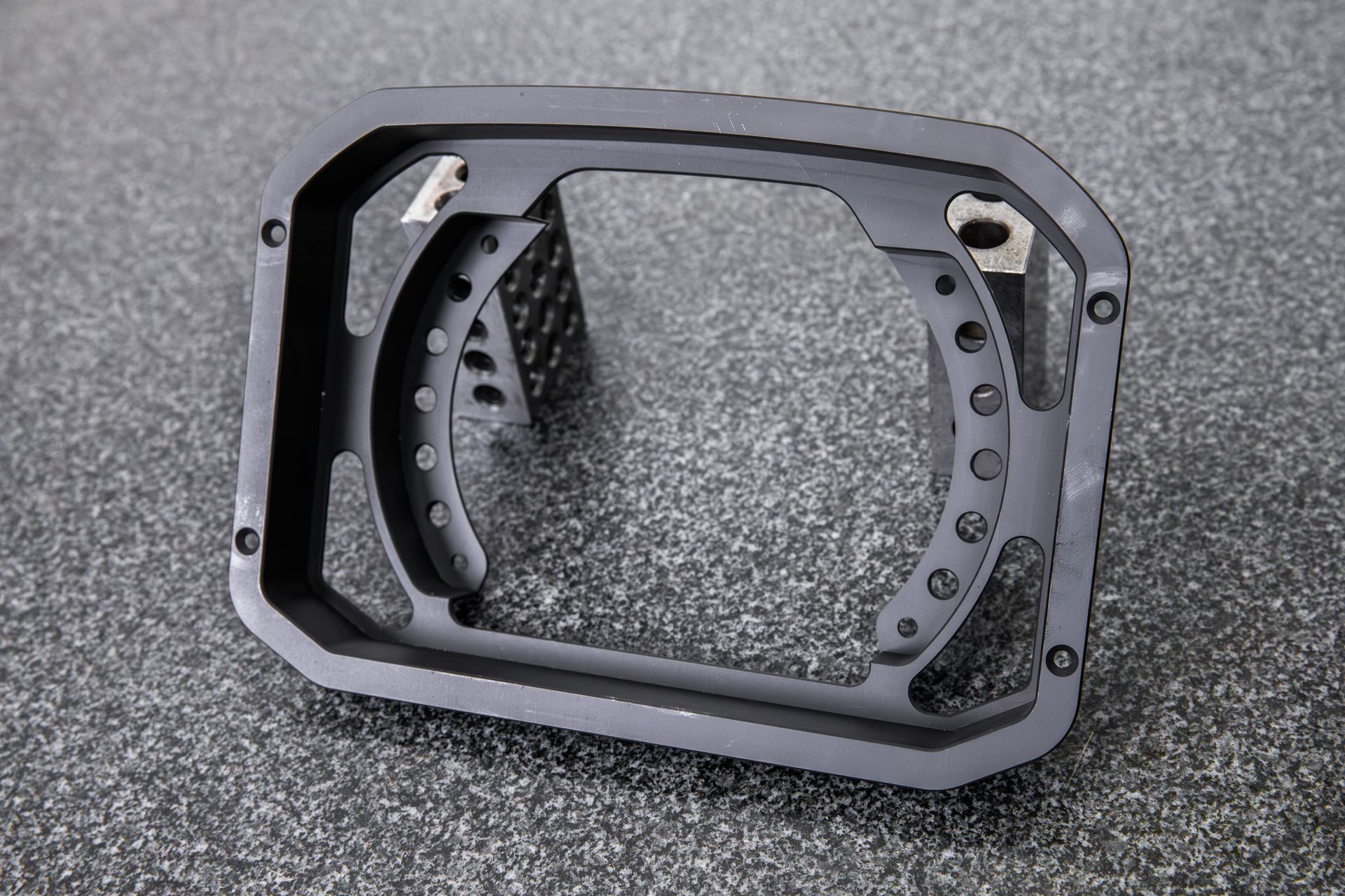 A black billet dash mount bezel made by Precision Metal Craft for an AEM CD7.