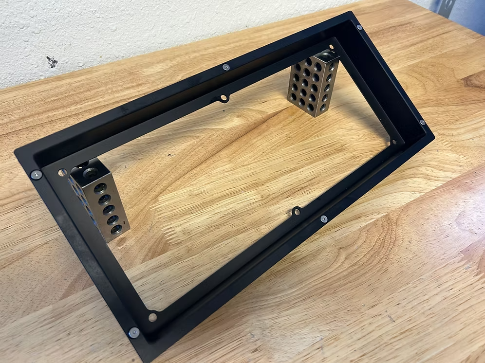 A black billet dash mount bezel made by Precision Metal Craft for a Holley 12.3.