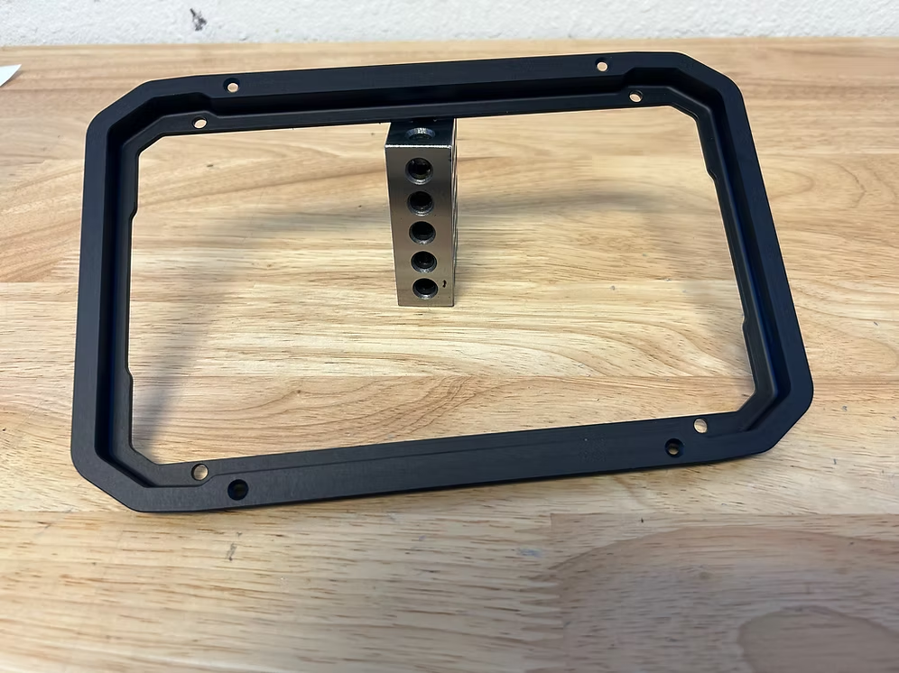 A black billet dash mount bezel made by Precision Metal Craft for a Lowrance GPS.