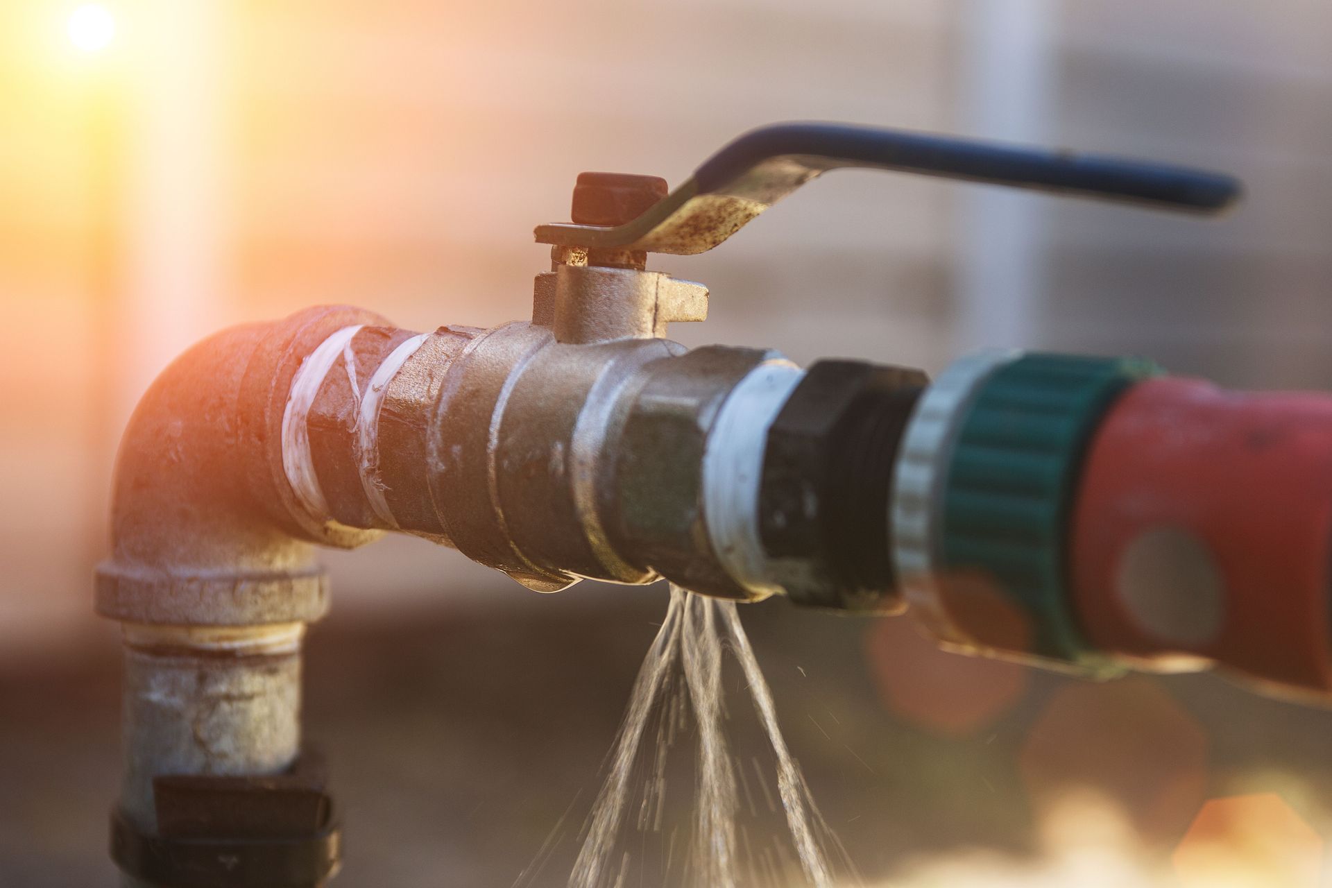 A close up of a faucet with water coming out of it.