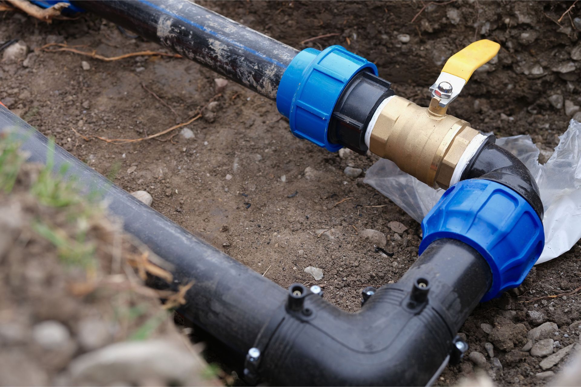 A close up of a water pipe with a valve attached to it.