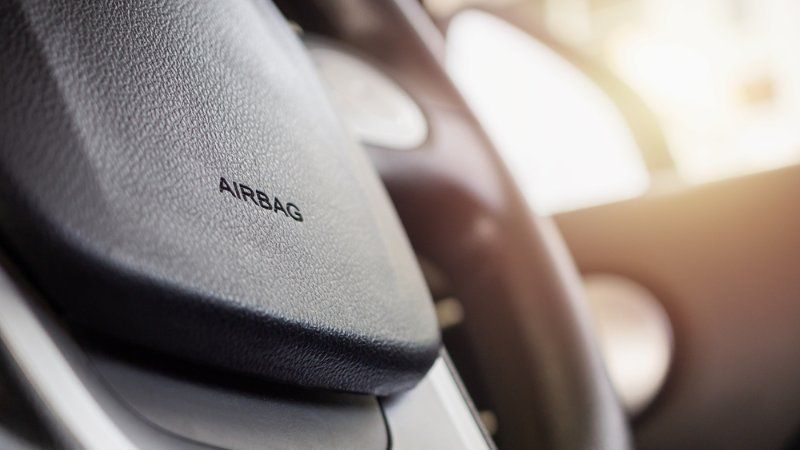 A close up of an airbag on the steering wheel of a car.