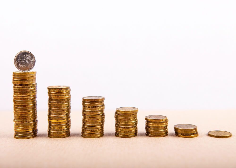 A row of gold coins stacked on top of each other on a table.