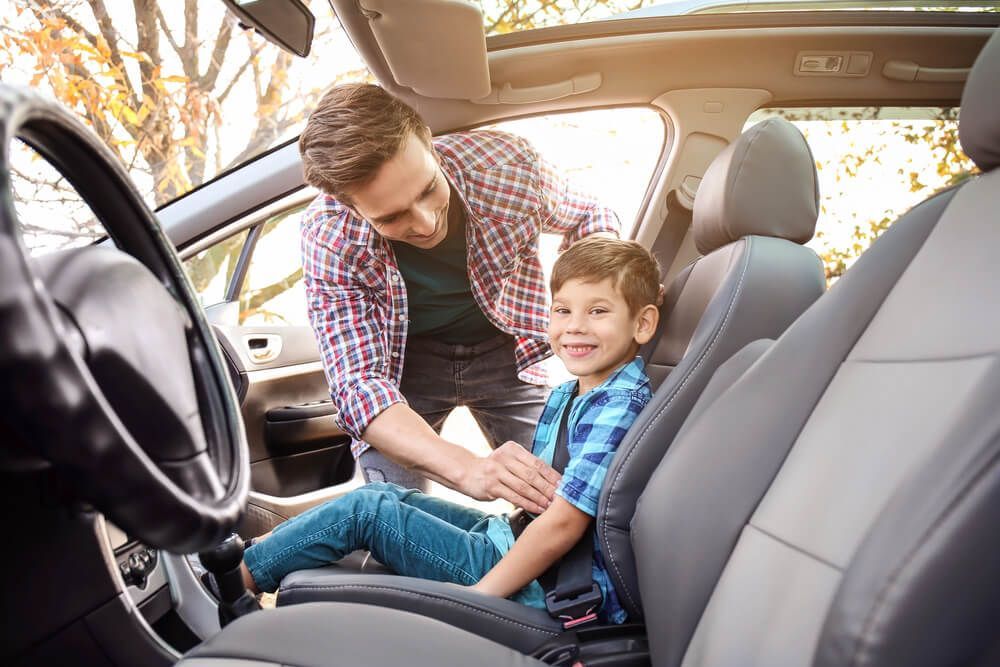 When can a kid sit in the front seat?