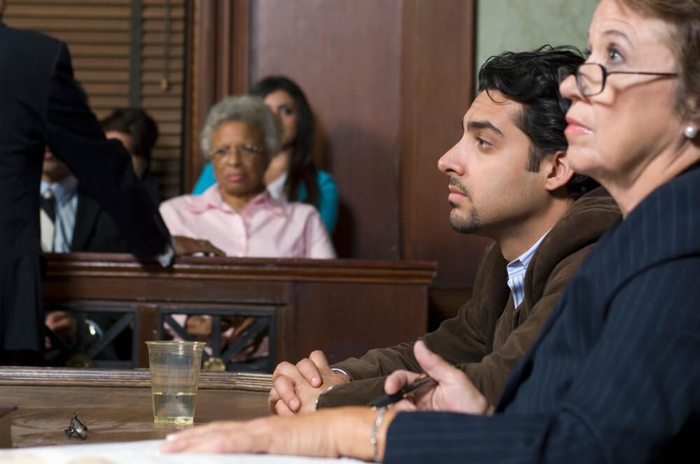 A man and a woman are sitting in a courtroom