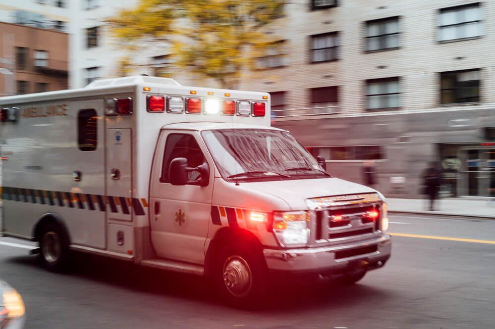 An ambulance is driving down a city street.