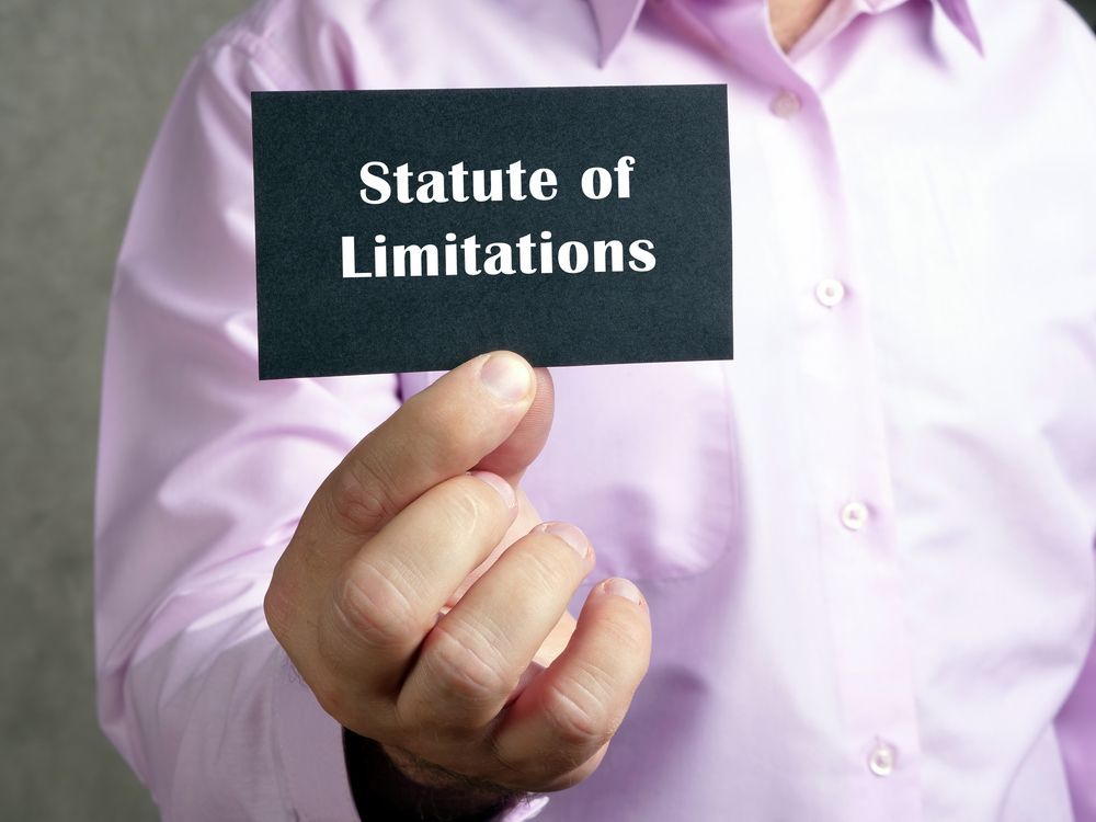 A person is holding a card that says statute of limitations